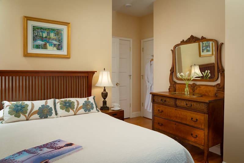 bedside desk drawer with mirror and vase of flowers