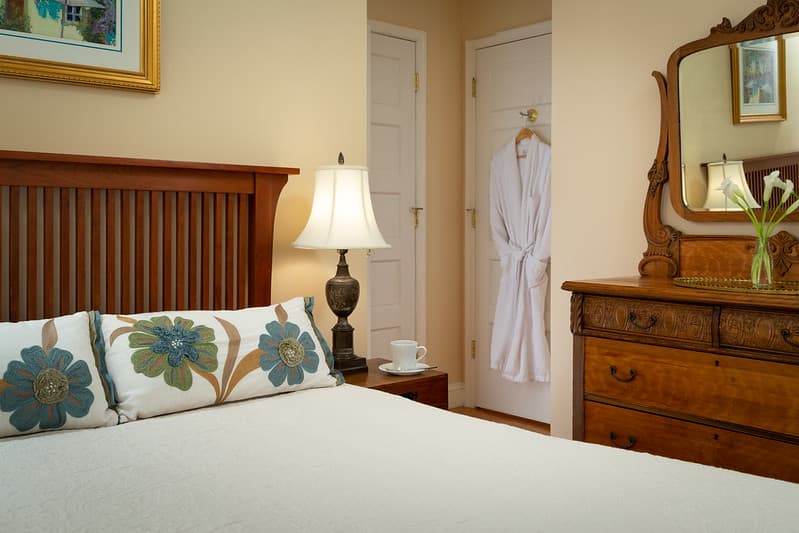bedside desk drawer with mirror and vase of flowers